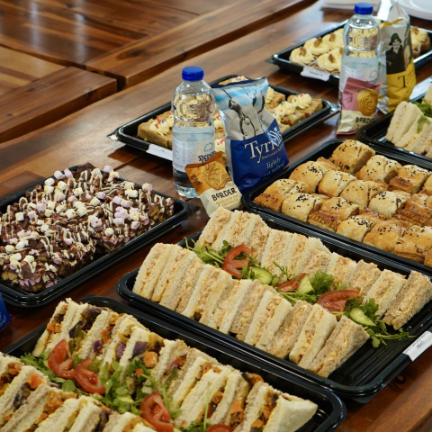 Esposito’s corporate catering banner featuring sandwiches and sweets